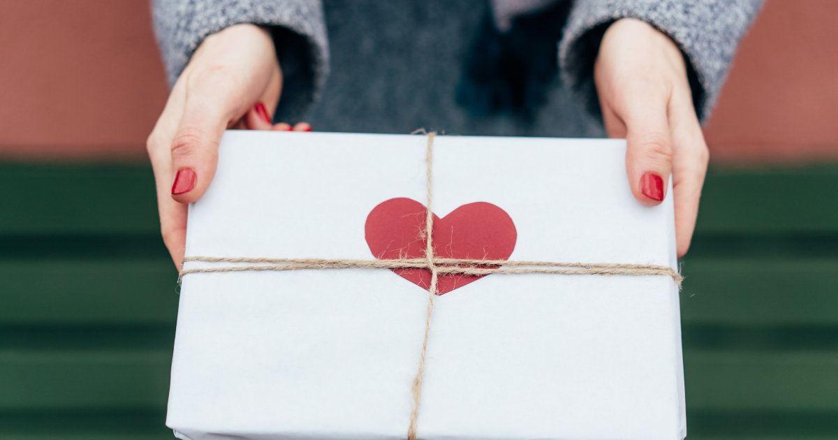 A woman holding a wrapped gift for valentine's day