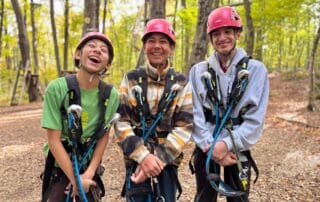sep2026-camp-03 Three students in climbing helmets and harnesses