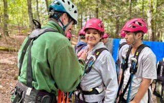 sep2026-camp-12 An instructor helping students with harnesses