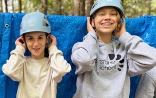 sep2026-camp-16 Two students in climbing helmets