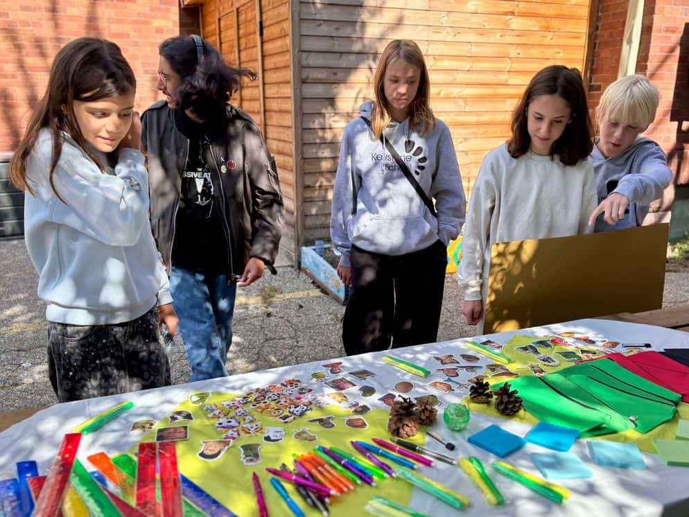 sep2026-house-2 Students at a House fundraiser table covered in colourful crafts