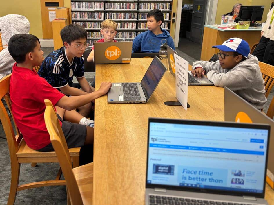 sep2026-newsletter-team-1 Newsletter Team students working on laptops in the library
